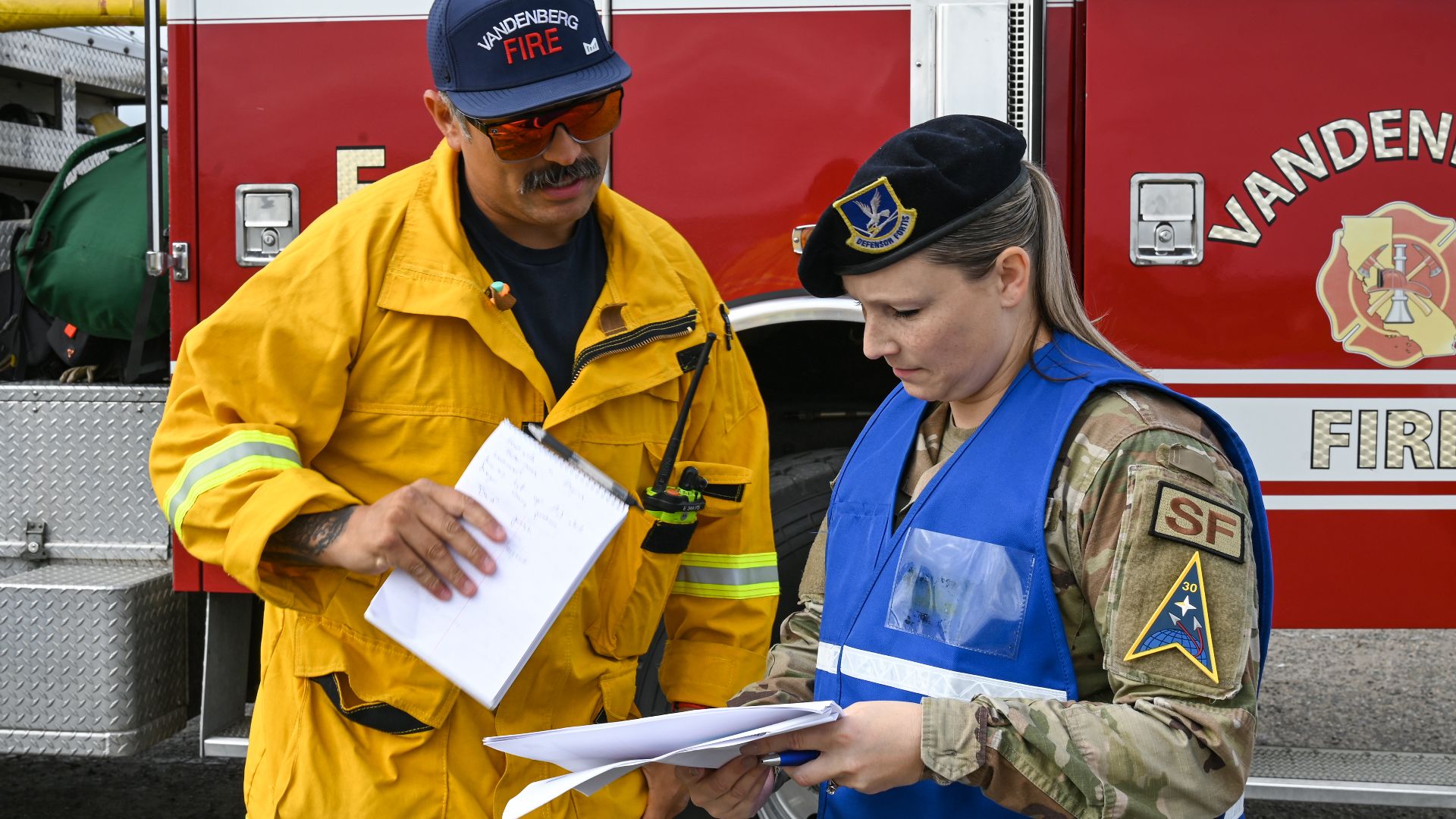 Joel Rodriguez, 30th Civil Engineer Squadron Fire captain explains his response to the Spacecraft Accident Emergency Management Evaluation to U.S. Air Force Master Sgt. Amy Johnson, 30th Security Forces Squadron Standardization and Evaluations chief and D