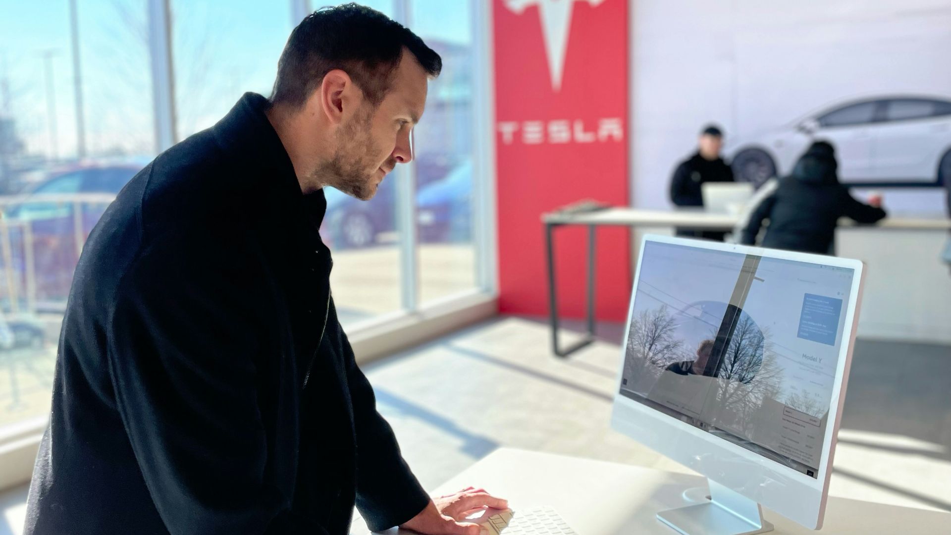 a man sitting at a desk in front of a computer