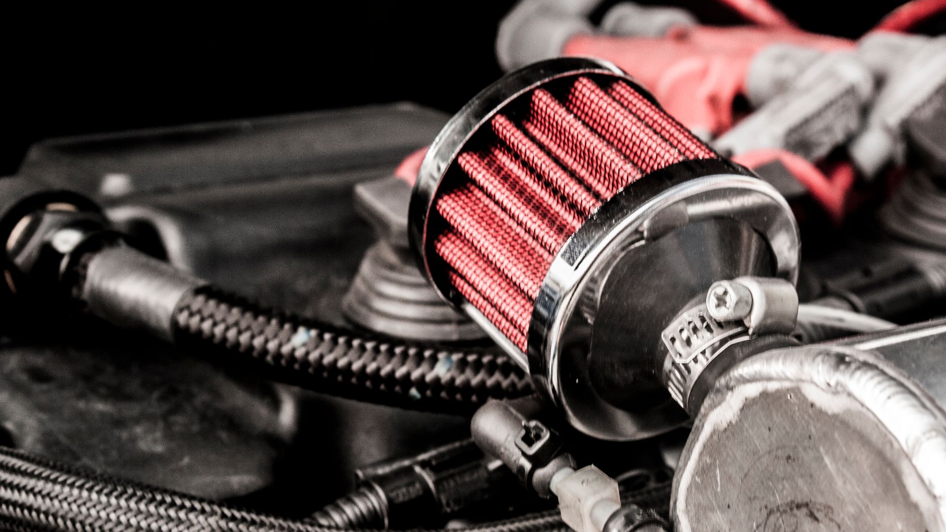 Close up of part of engine under the hood of a car.