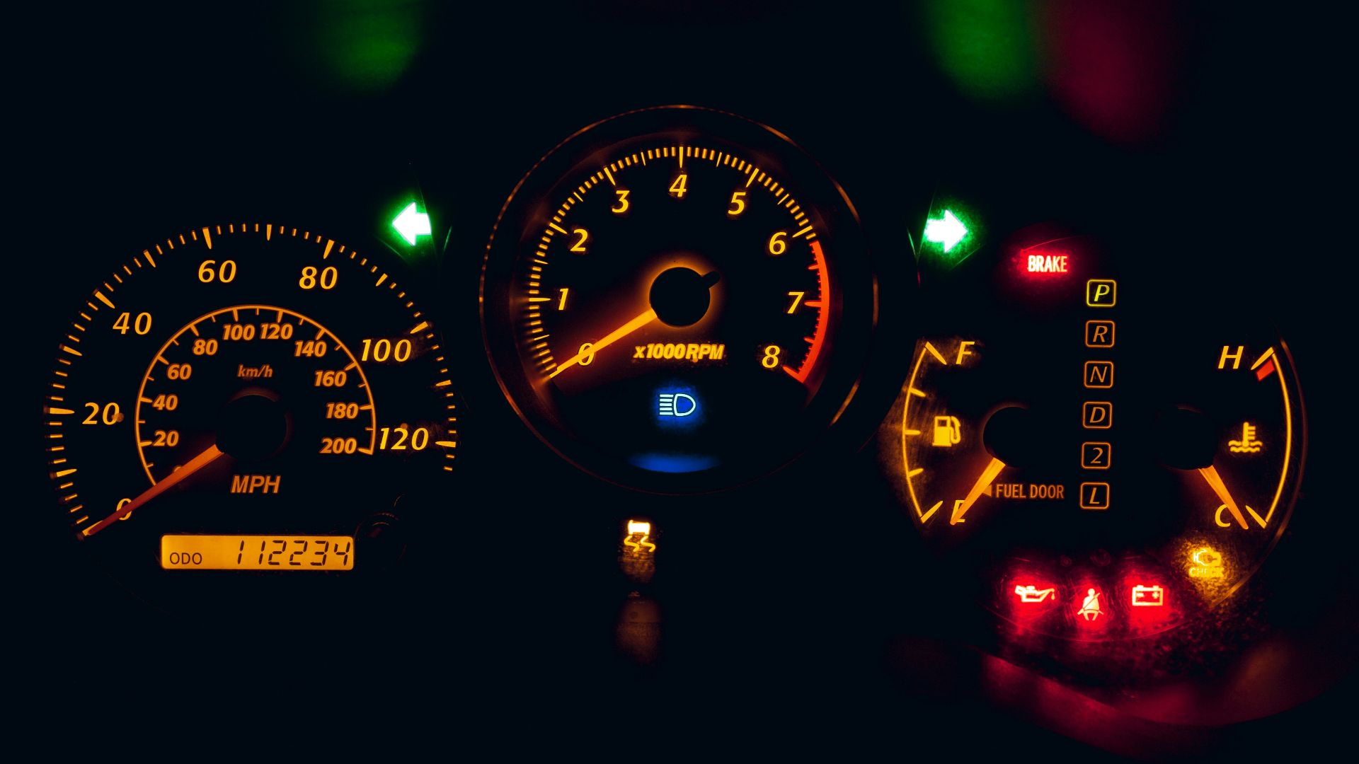 black and yellow analog speedometer