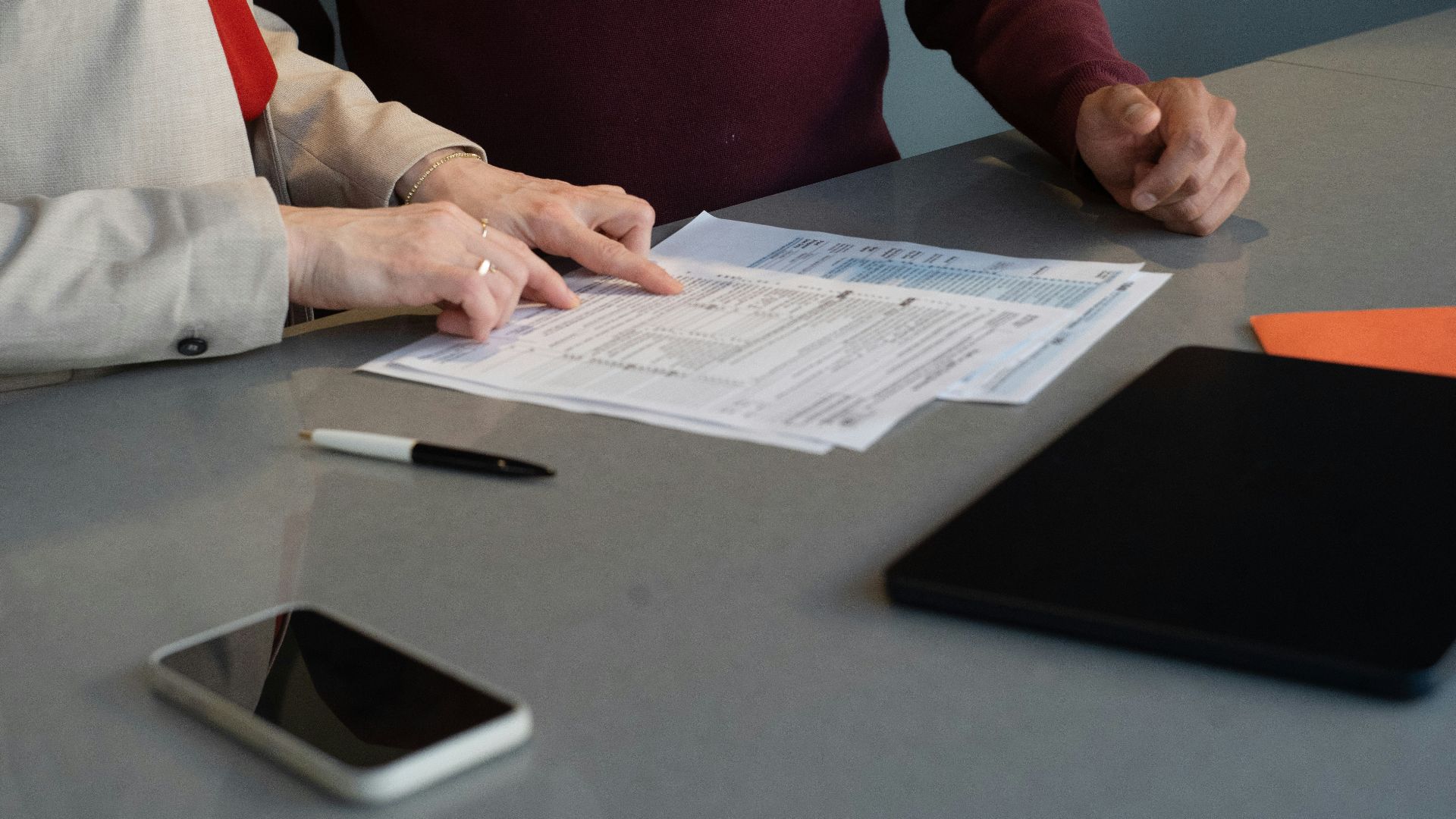 Two people reviewing documents at a table