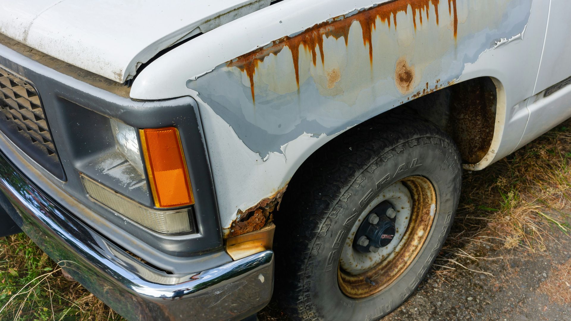 an old white truck with rust on it