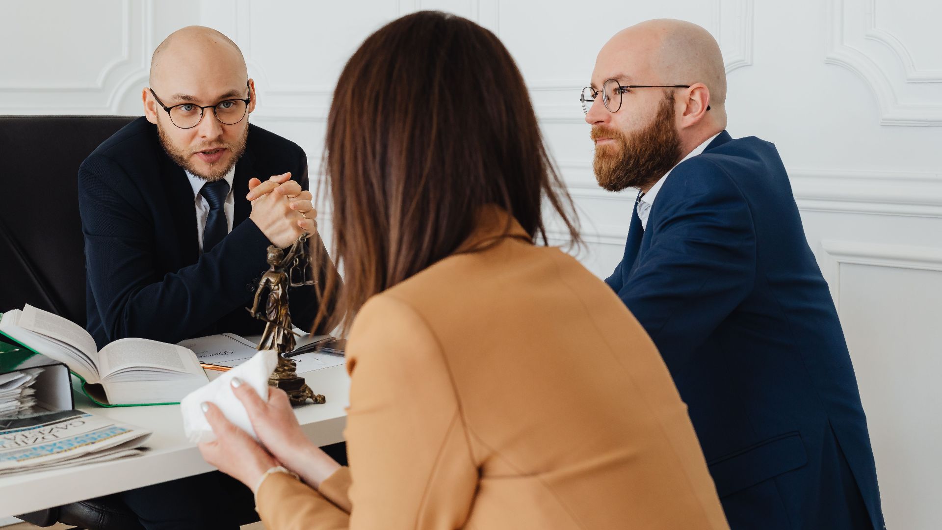 Professional discussion among lawyers in a modern office, focusing on legal matters.