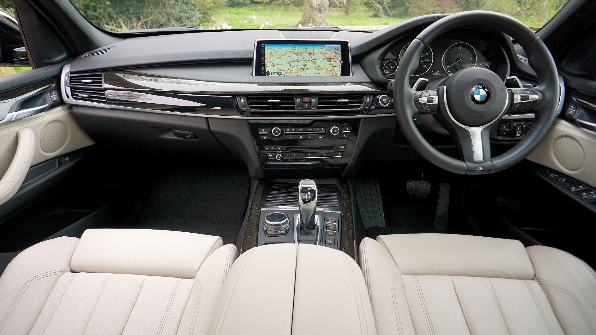 Explore the sleek interior of a BMW featuring a detailed dashboard and GPS navigation system.