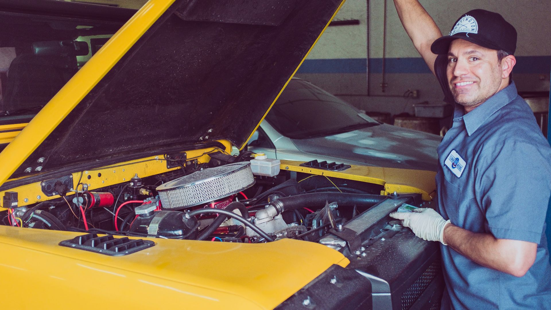 man holding open-wide car trunk