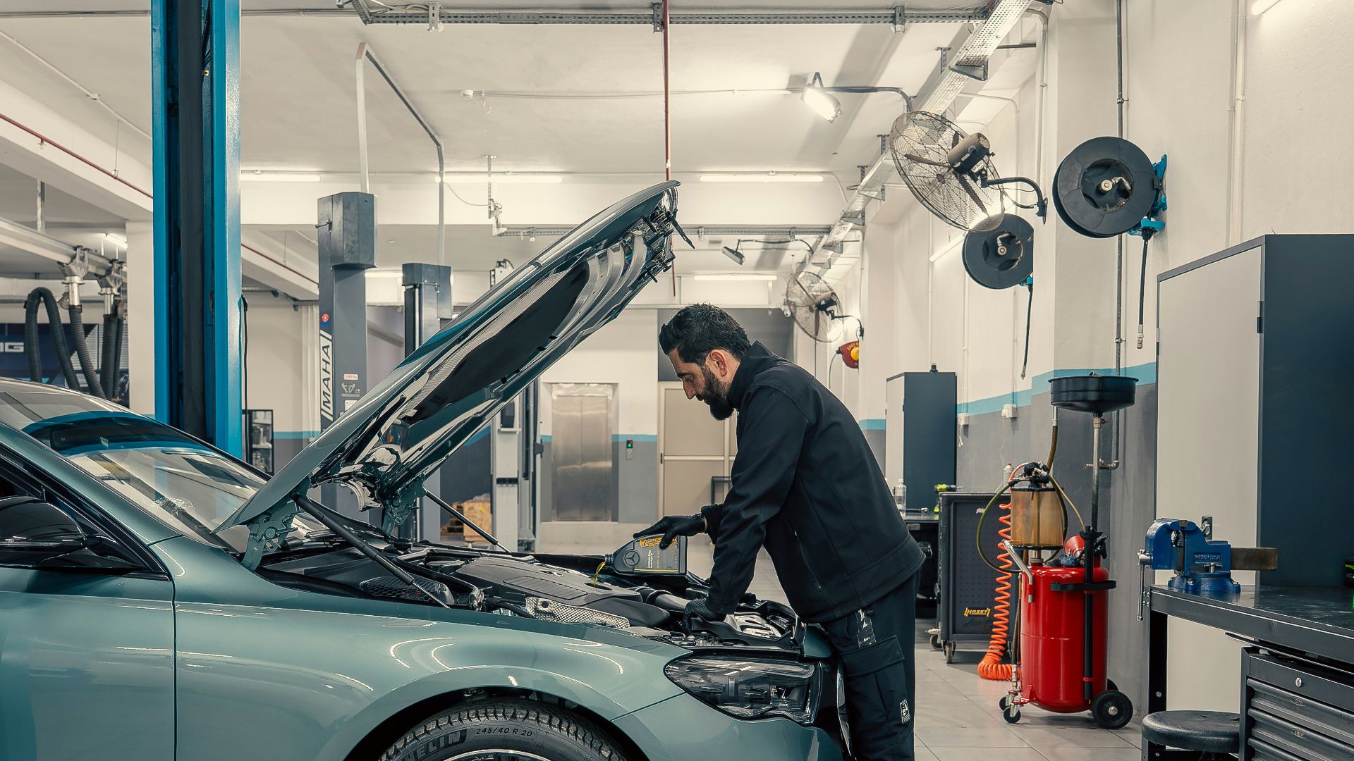 Mechanic working on a car engine in a workshop