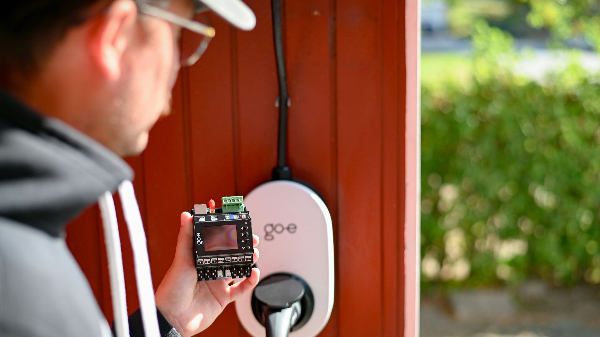 Man is examining an electric vehicle charger