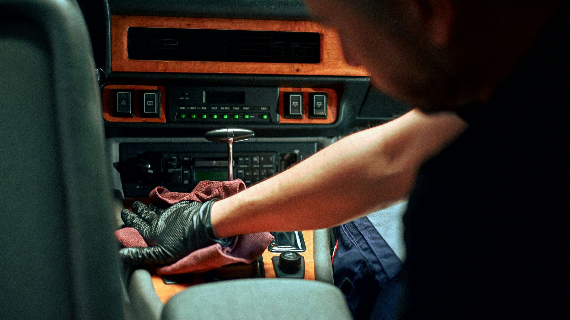 Mechanic working on car interior dashboard
