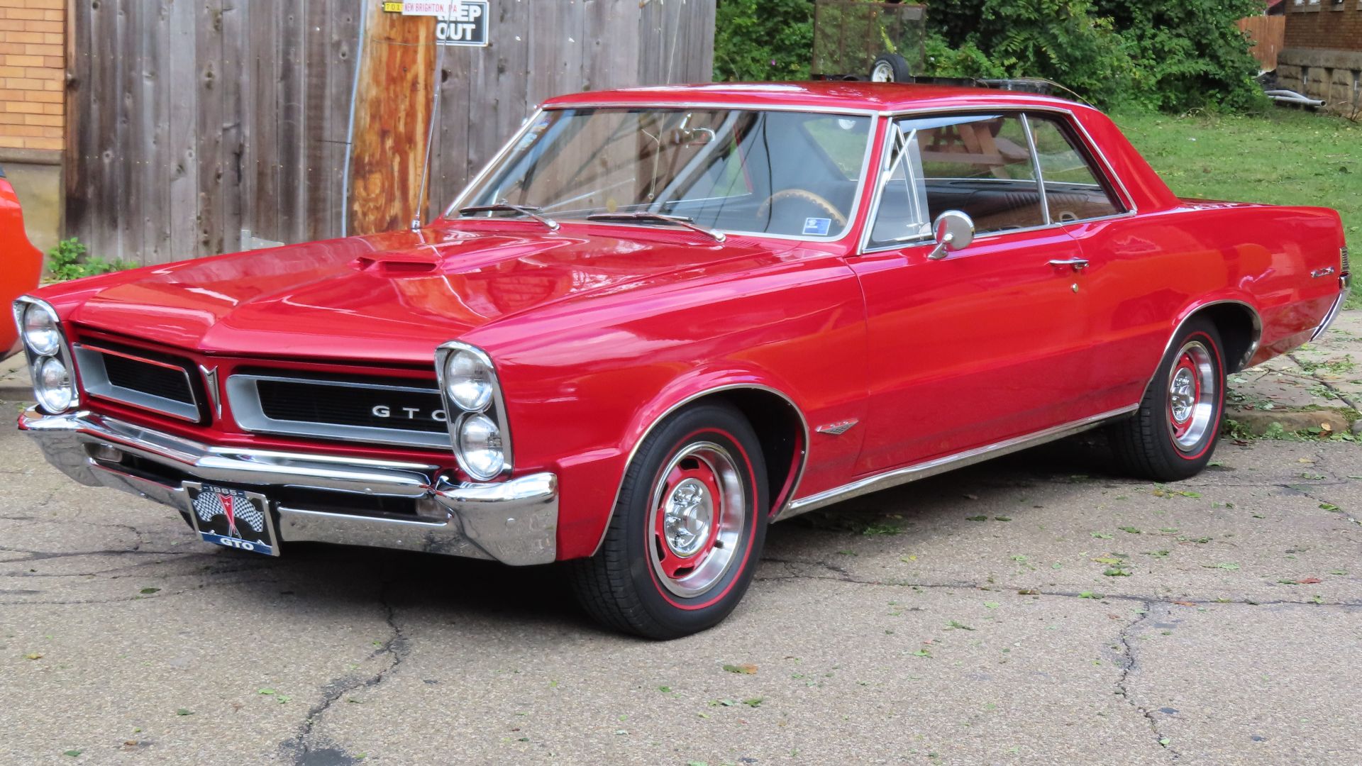 1965 Pontiac GTO hardtop photographed at the 2024 New Brighton Car Cruise in New Brighton, Pennsylvania. Finished in Montero Red.