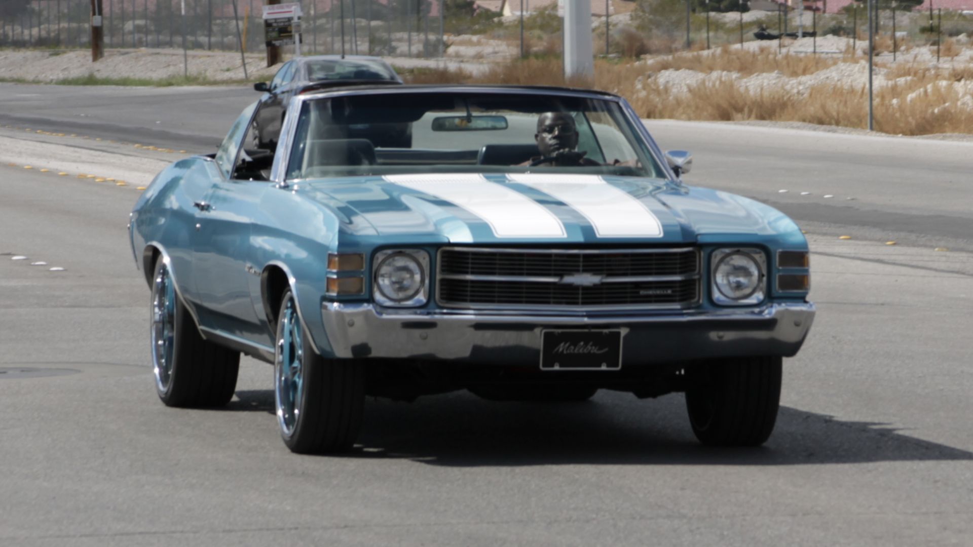 A blue 1971 Chevrolet Chevelle driving in the eastbound lane of West Lone Mountain Road, North Las Vegas, Nevada.