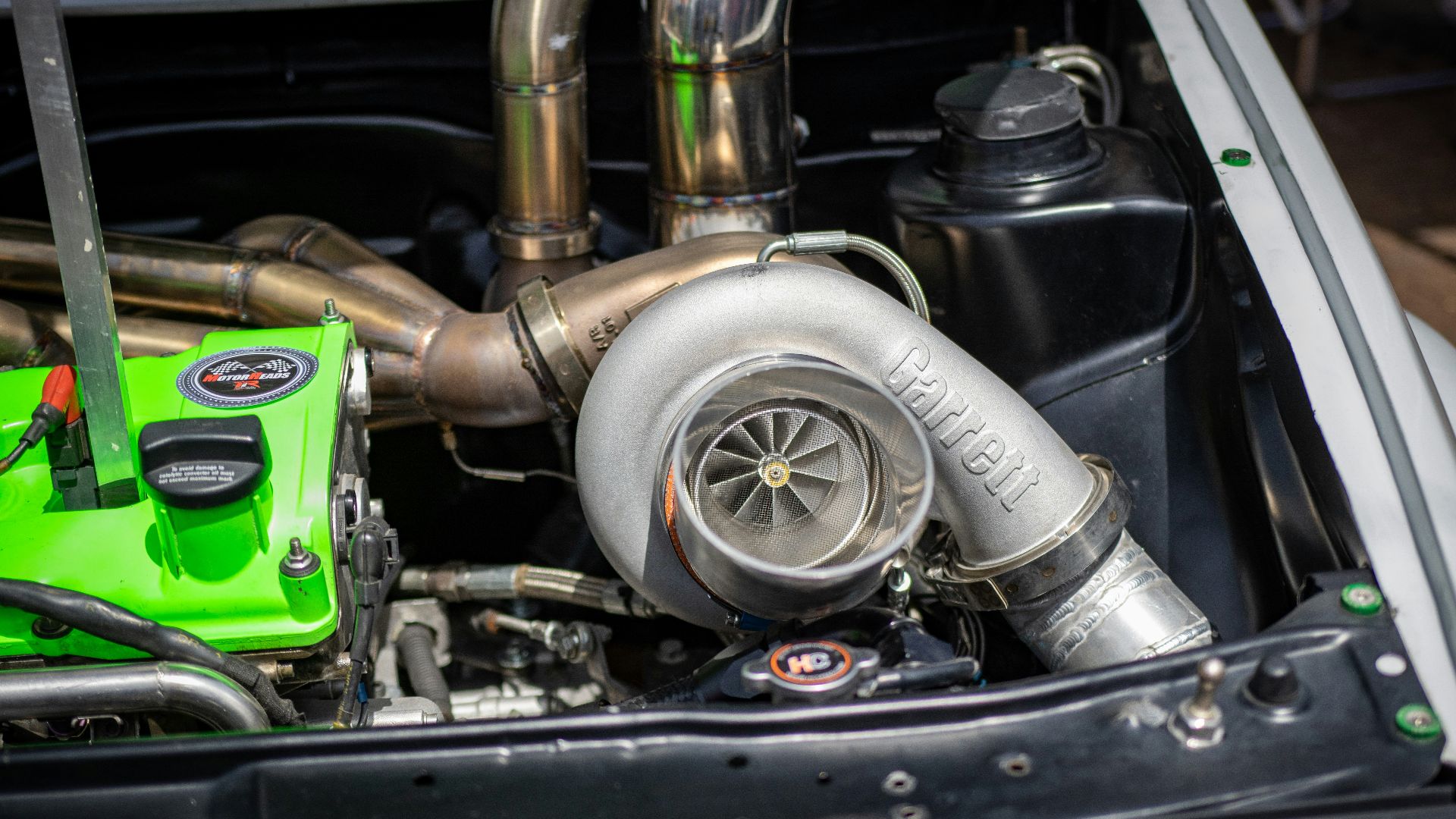 the engine compartment of a car with a green engine