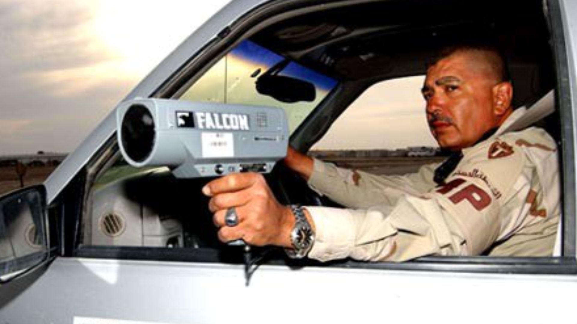 TALLIL AIR BASE, Iraq -- Army Sgt. Jessie DeLarosa uses a custom signal Falcon K-band police radar gun to catch speeding violators here. He is a military policeman with the Texas Army National Guard's 36th Infantry Division and is deployed from San Antoni