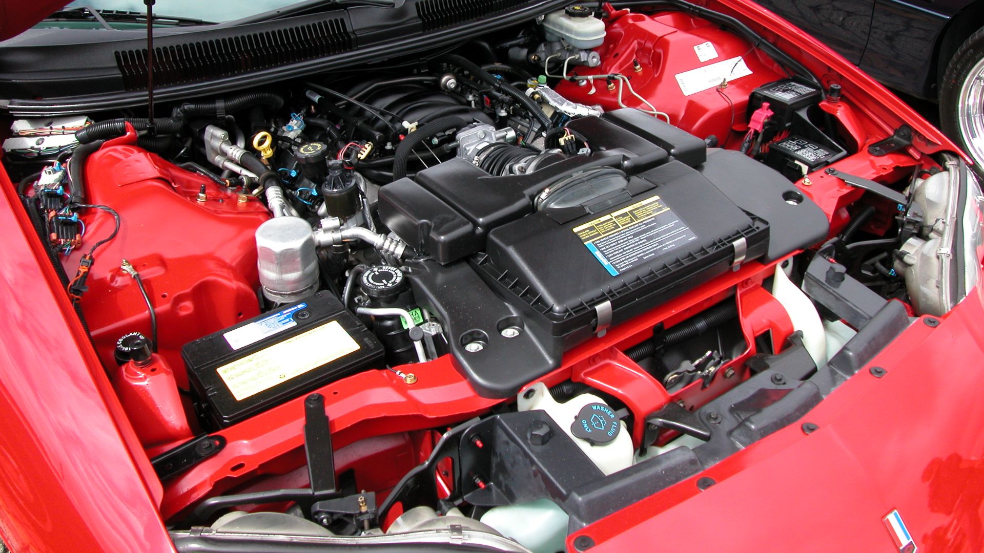 This is an image of GM's stock 5.7L LS1 V8 engine that outputs 305hp. This is from my 1998 Chevrolet Camaro Z28 and was taken during the 2003 Super Chevy Show in Pomona, CA. The camera used is a Nikon Coolpix 5000.