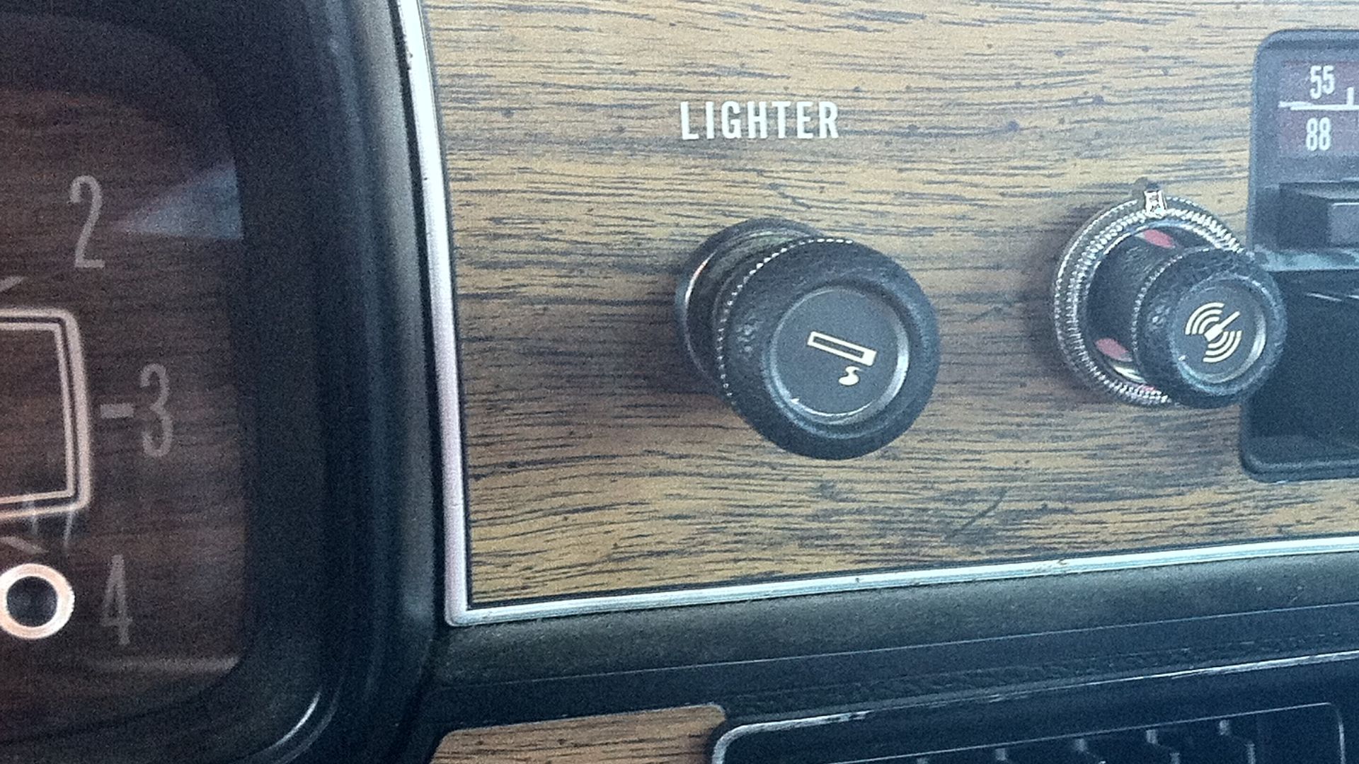 Detail of the factory installed AM/FM/8-track stereo audio unit in the instrument panel of a 1978 AMC Matador four-door sedan (made by American Motors Corporation). Also shown is the a tape cartridge in