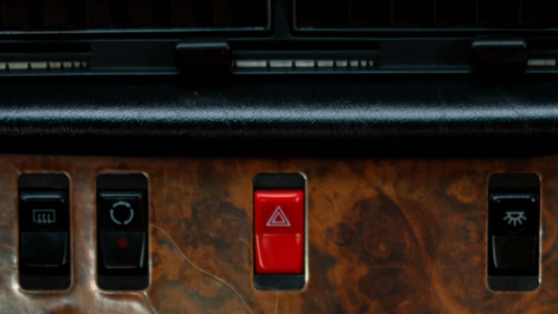 Close-up of a classic Mercedes W126 car interior focusing on the gearbox and controls.