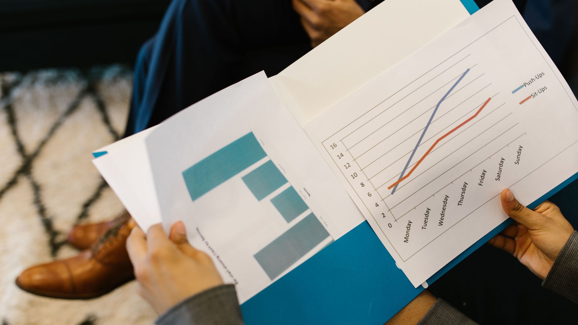 Detailed view of business reports with graphs during a corporate meeting.