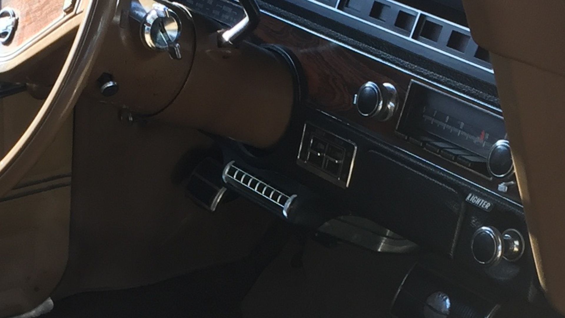 1970 Chevrolet Kingswood Estate. A surviving original factory condition four-door station wagon with three rows of seats, with the rearmost one facing backwards. Finished in beige with woodgrain paneling trim on bodysides and tailgate. This car also has t
