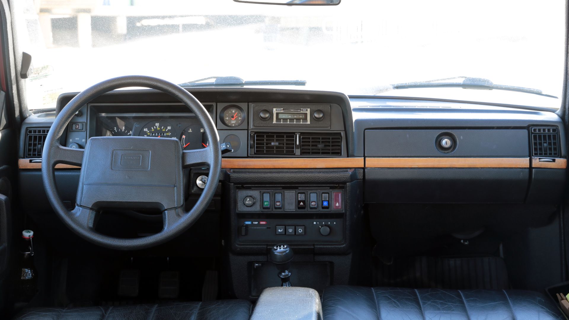 Dashboard of a 1993 Volvo 240 Classic Wagon (aka 245). Leather, wood trim, and all the goodies came standard on the Classic. This car has a digital thermometer in place of the numbered plaque that these cars originally came with. Already published on Flic