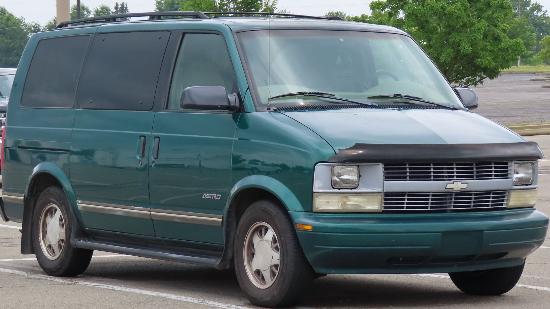 1998 Chevrolet Astro Base Passenger Van photographed in New Castle, Pennsylvania. This one is finished in Dark Forest Green Metallic and features sealed beam headlights, standard equipment on the base model. Though relatively common in cargo van form, the
