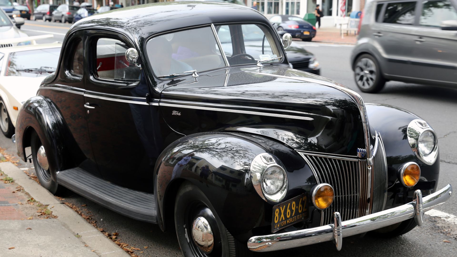 A 1940 Ford Standard Business Coupé. Serie 01A, 85hp model, body 67A. Vintage 1940 license plates; they have been altered so as to anonymize them.