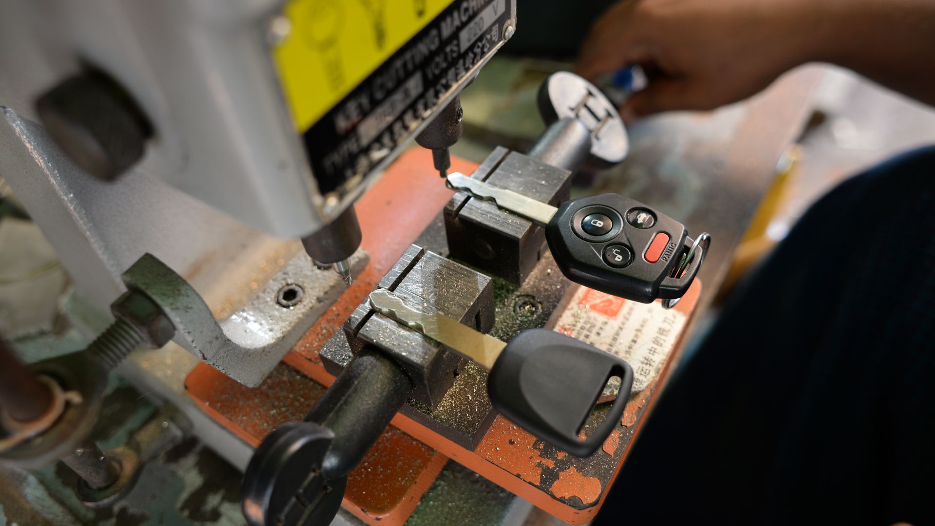 Car key being duplicated with a key cutting machine.