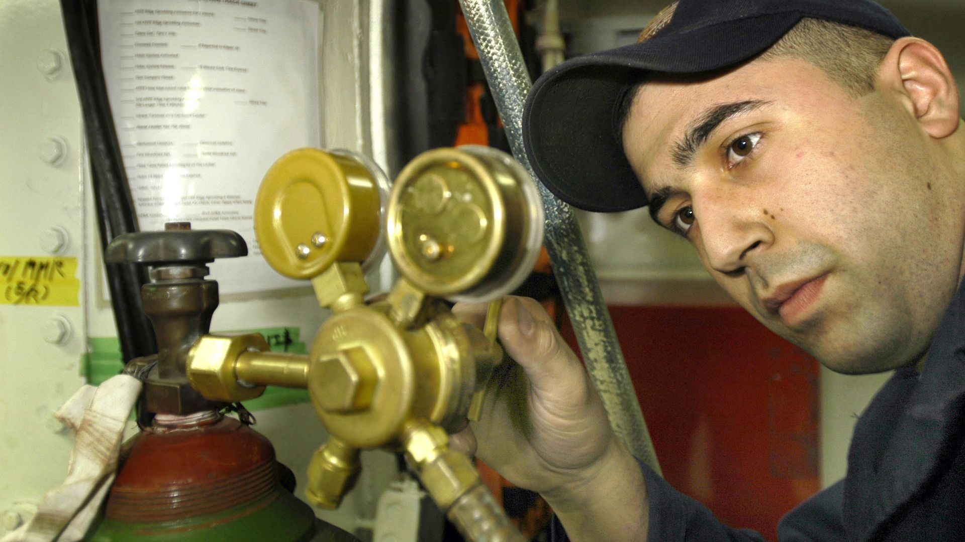 Yokosuka, Japan (Jan. 13, 2006) - Hull Maintenance Technician Fireman Dave Norris, sets the pressure of an oxygen tank prior to using an oxyacetylene torch, during the Ship’s Restricted Availability (SRA) aboard the conventionally-powered aircraft carrier