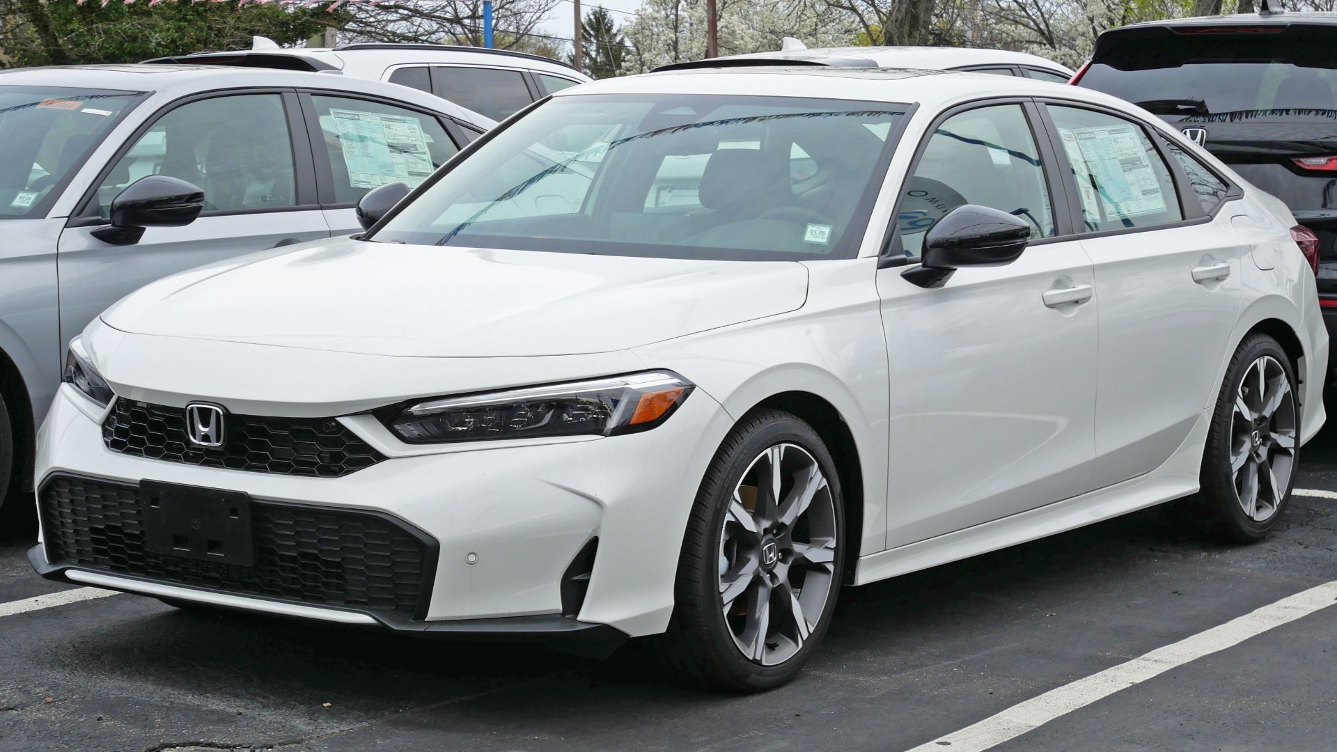 A 2025 Honda Civic Hybrid Sport Touring facelift photographed in Manhasset, New York, USA