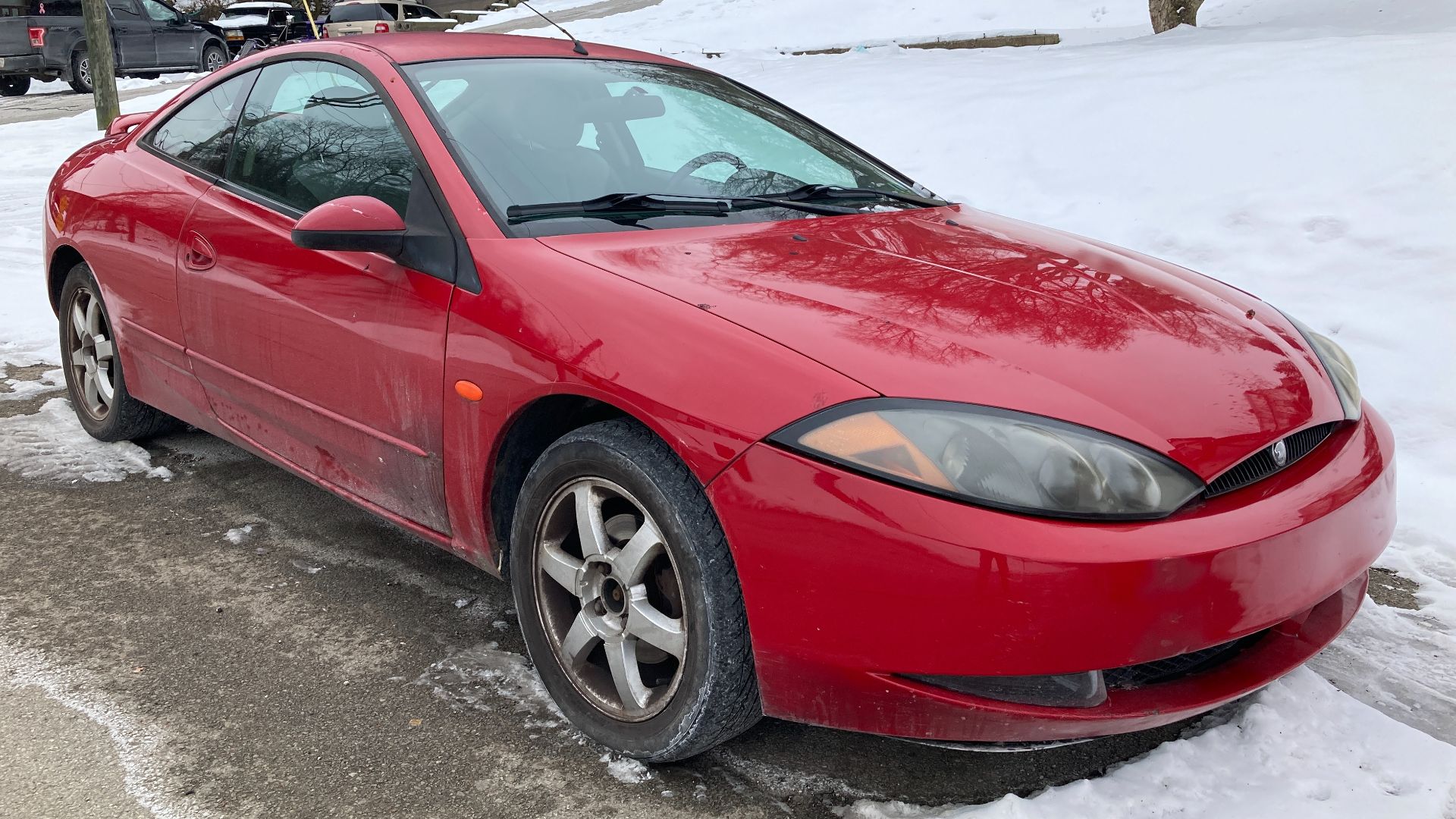 A 1999 Mercury Cougar V6 in Rio Red. This Cougar is equipped with the 2.5L V6 engine, and assembled in Flat Rock Michigan. Nice to see one of these in 2022.