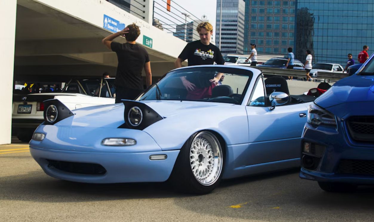 a blue sports car parked next to a blue sports car