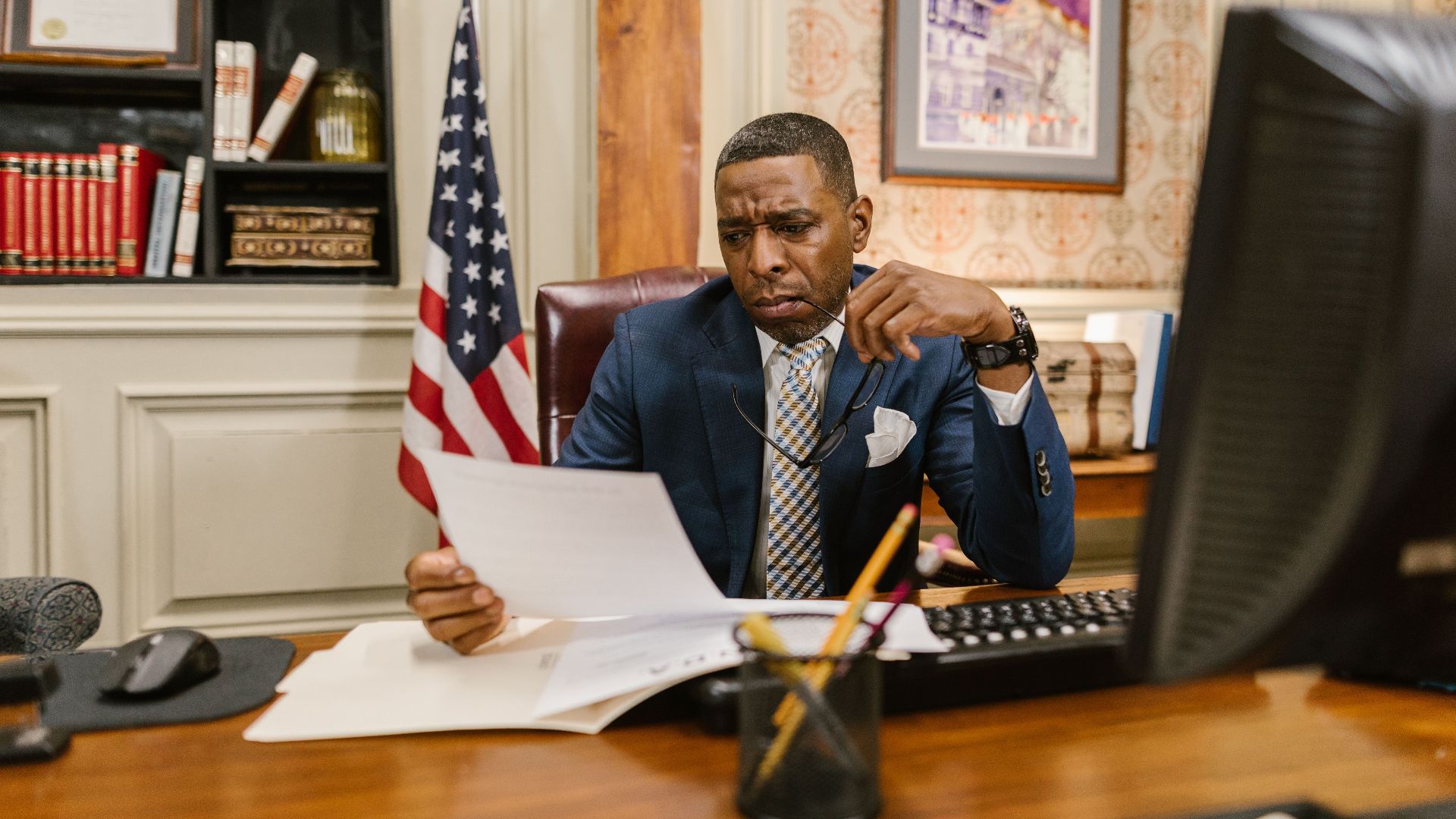 A focused lawyer reading documents in an office, symbolizing professionalism and legal expertise.