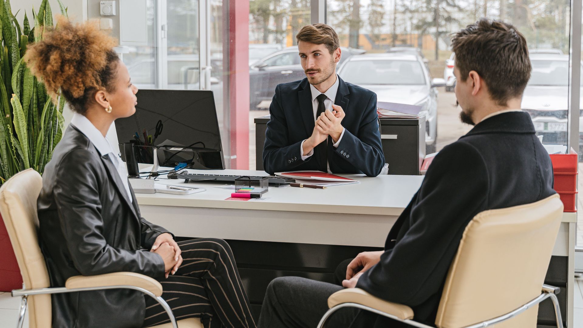 Professional meeting with clients at a modern office, discussing business solutions.