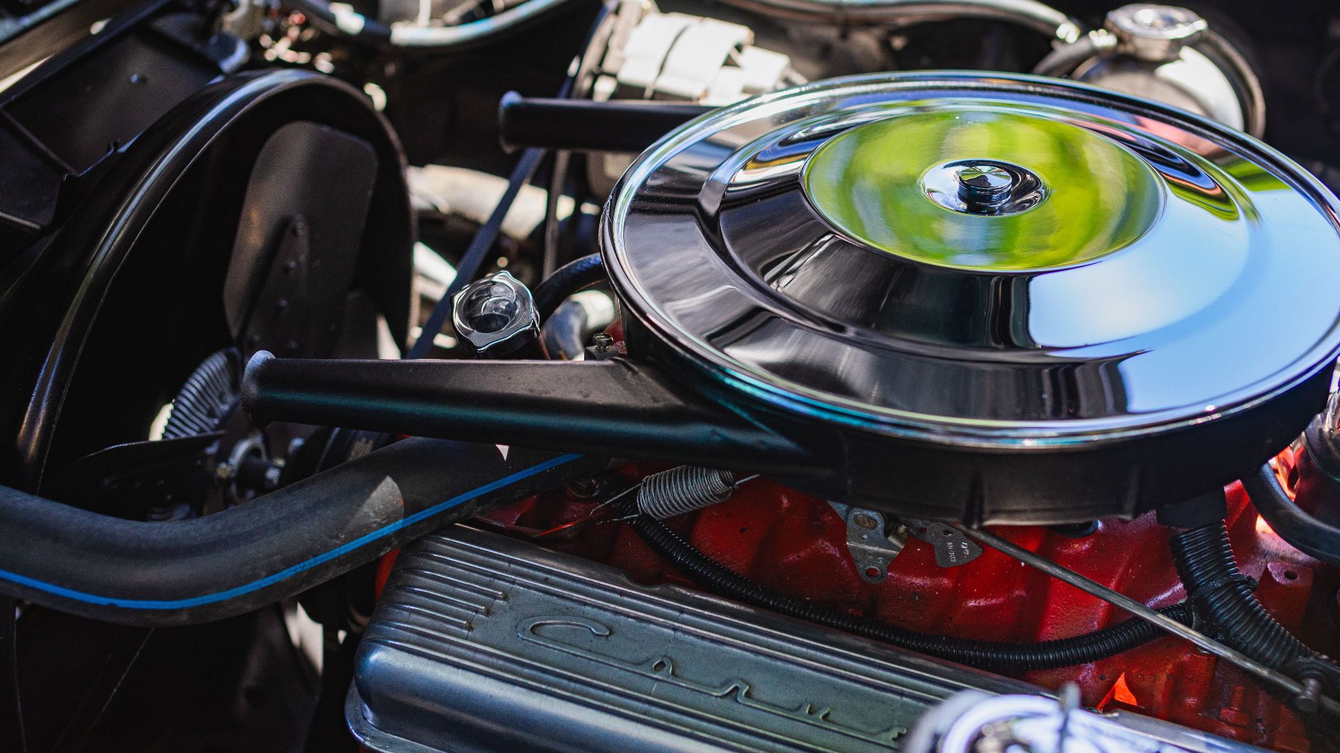 Detailed view of a classic car engine, highlighting parts and mechanics.