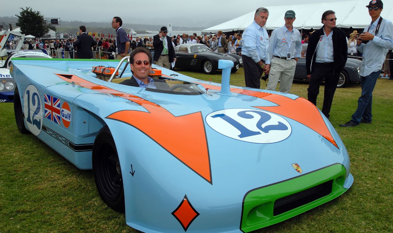 Getty Images - 593381744 - Jerry Seinfeld drives his vintage Porsche 917, made famous by the movie Le Mans, in Monterey Saturday, August 15, as part of the Monterey Historic car event.