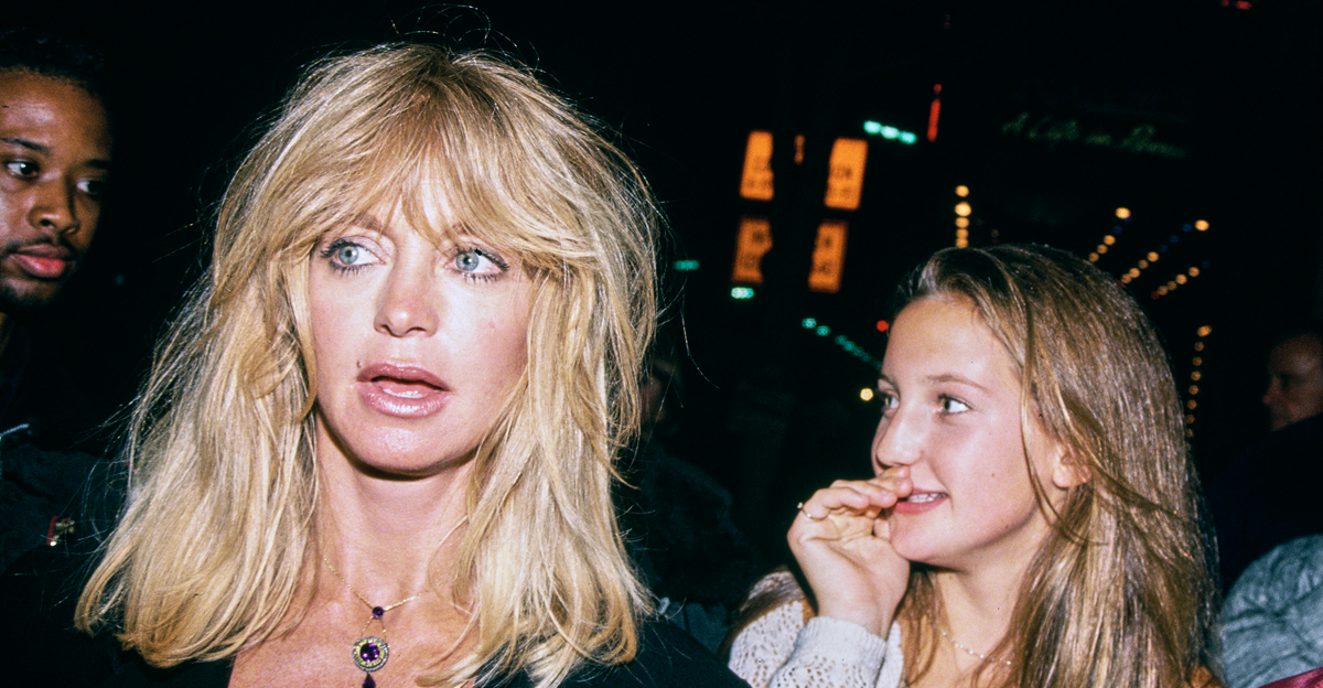 American actress Goldie Hawn, wearing a black outfit, and her daughter, American actress Kate Hudson, attend an event in the Hollywood neighbourhood of Los Angeles, California, 1993.