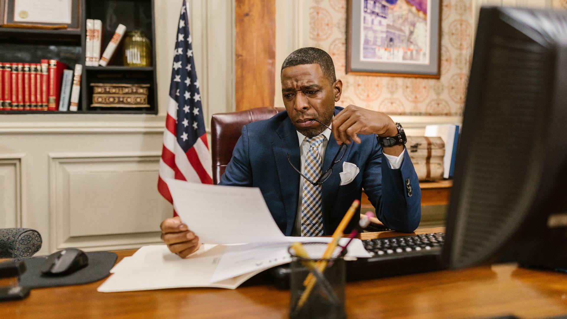 A focused lawyer reading documents in an office, symbolizing professionalism and legal expertise.