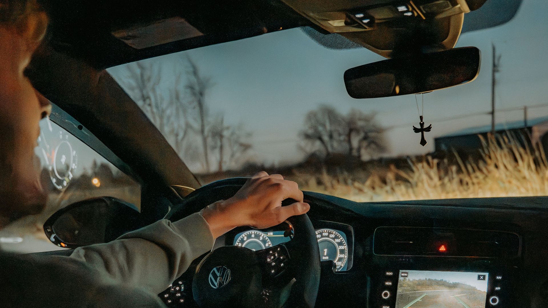Experience the serene ambiance of a night drive with this view of a Volkswagen car interior featuring modern technology.