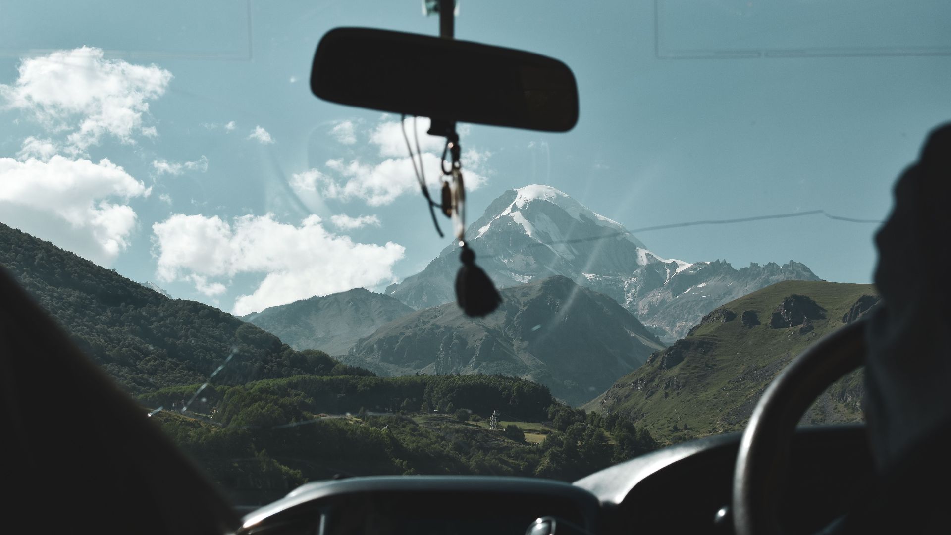 View of stunning mountain landscape through a car windshield. Perfect for travel and adventure themes.