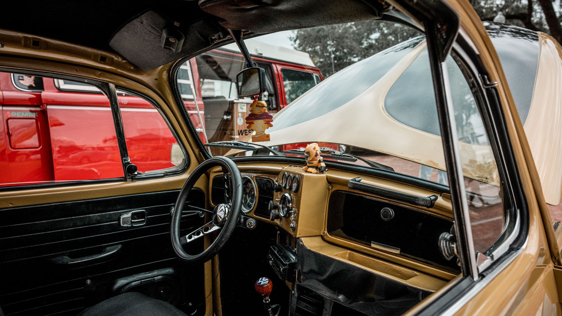 Explore the classic interior of an old-fashioned Volkswagen Beetle with detailed steering wheel and dashboard.