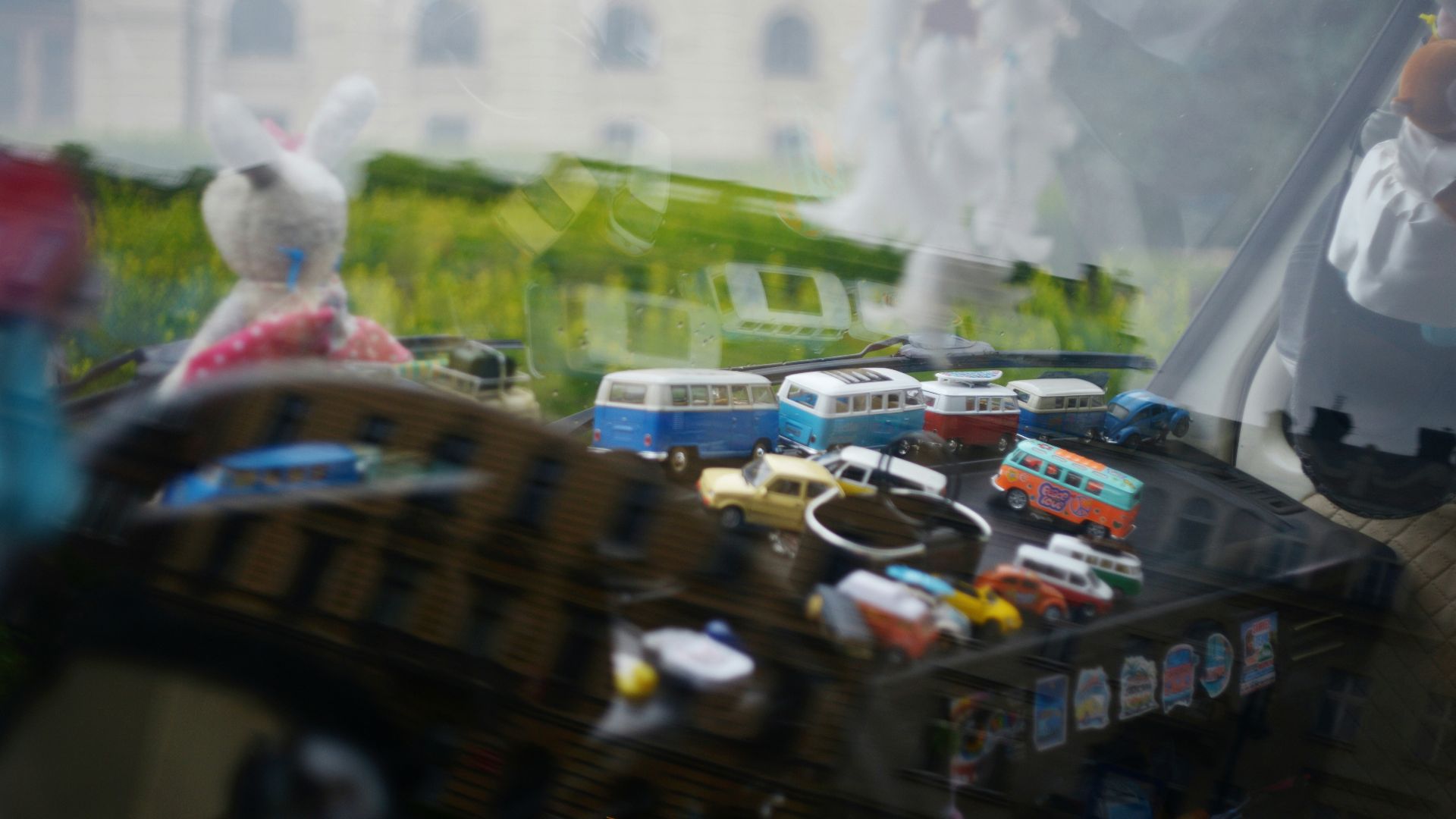 Miniature vintage toy vehicles displayed in an open suitcase