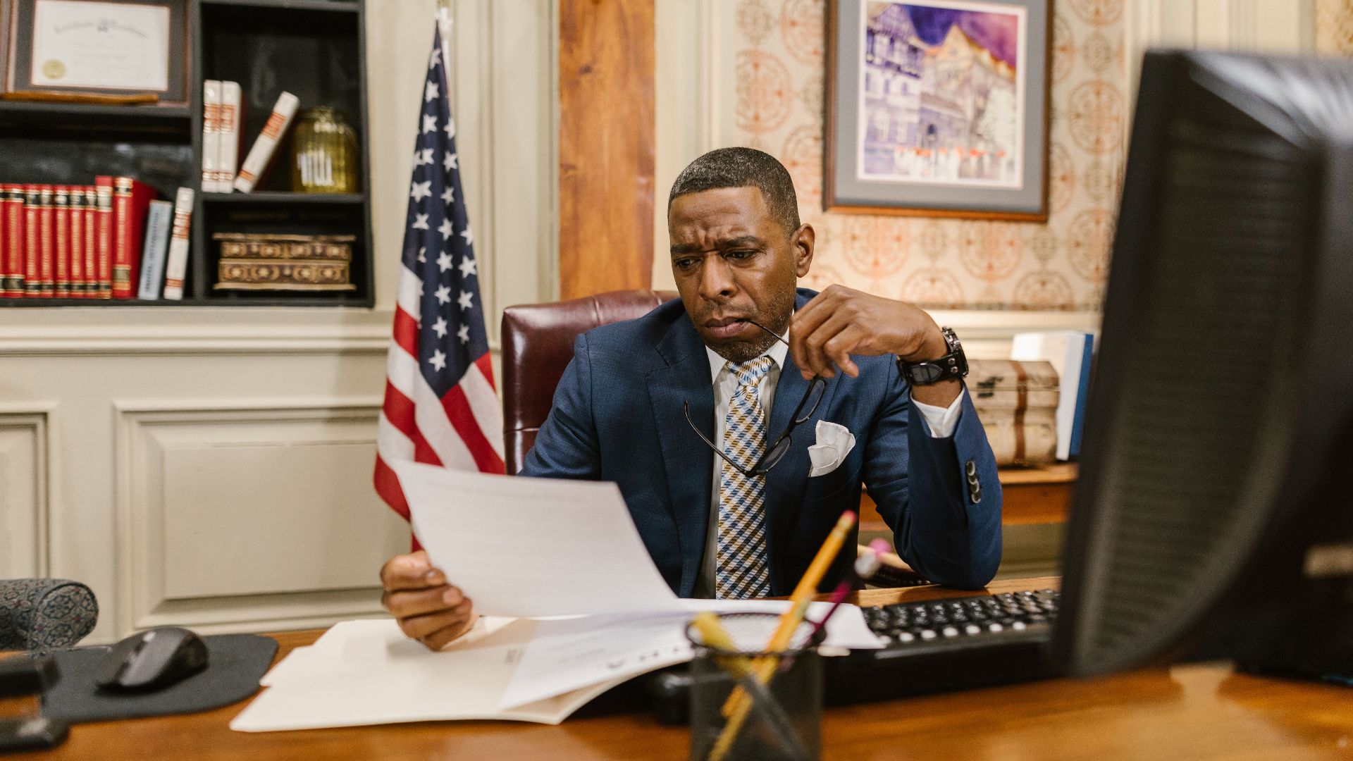 A focused lawyer reading documents in an office, symbolizing professionalism and legal expertise.