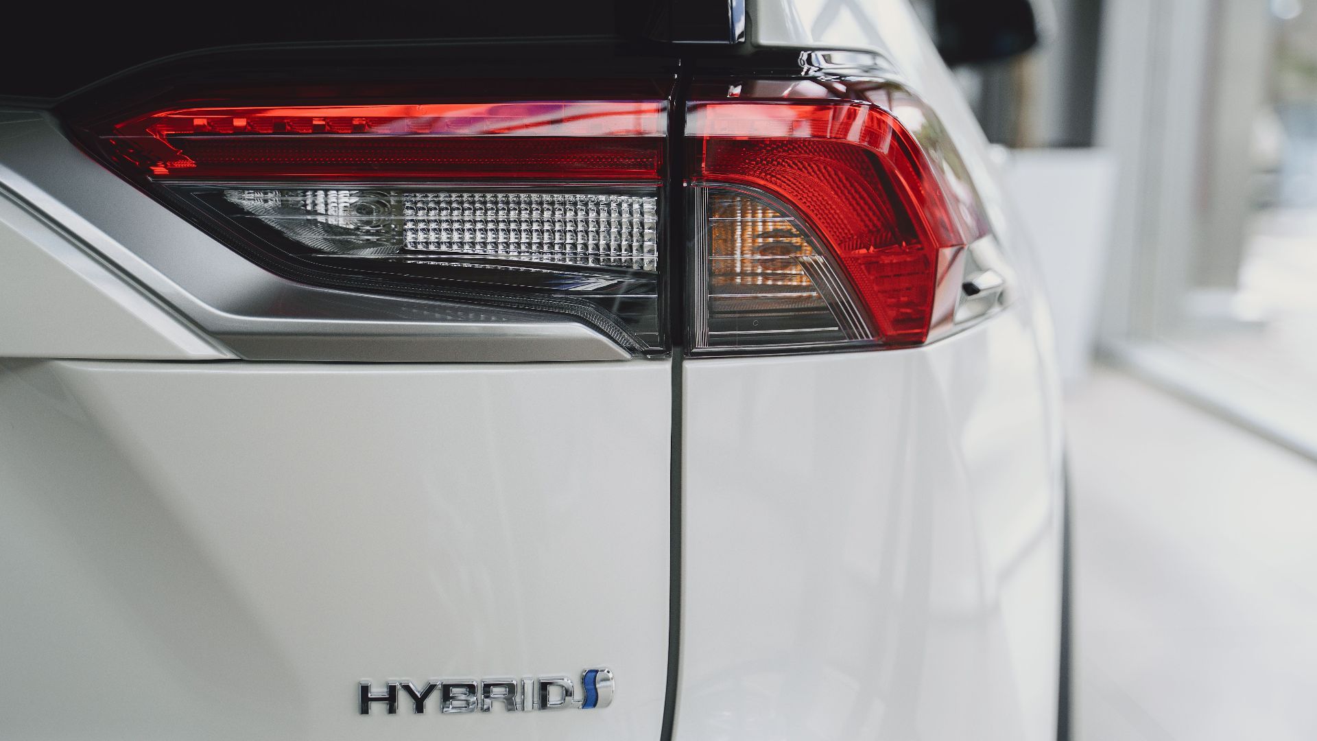 Elegant close-up of a hybrid car tail light showcasing modern automotive design.