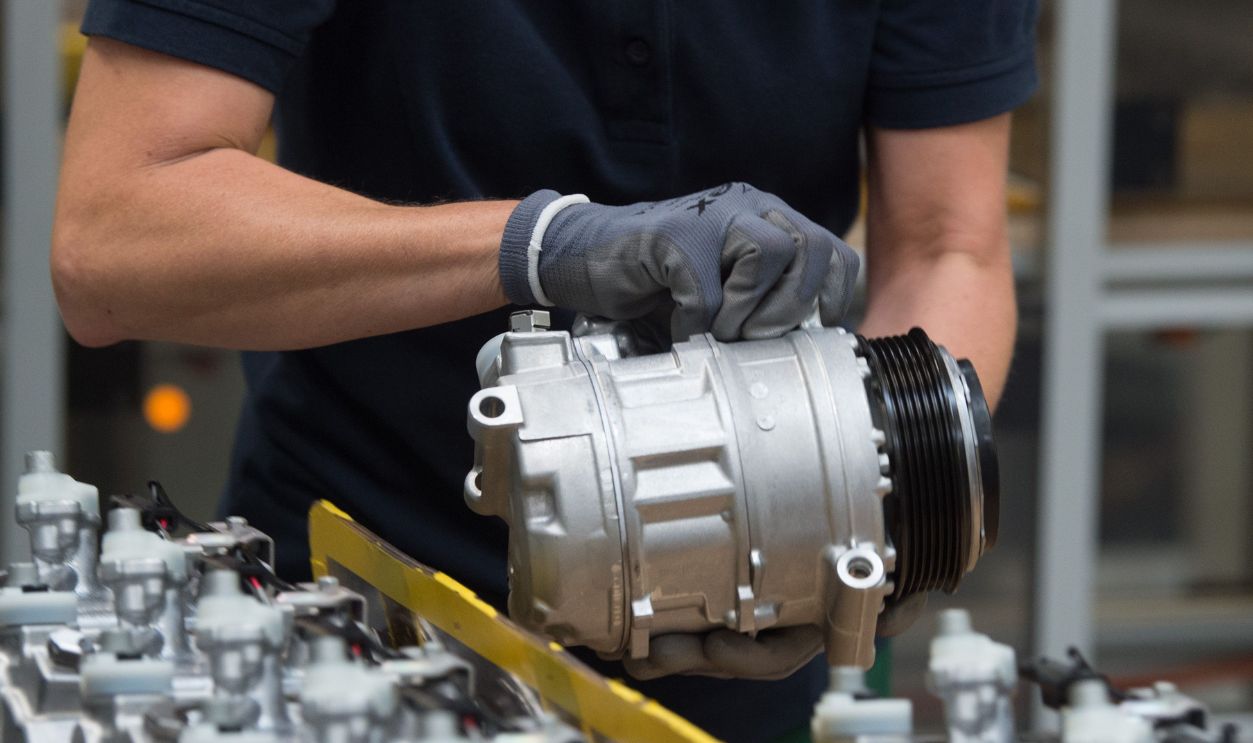 An employee of TD Deutsche Klimakompressor GmbH (TDDK) sorts compressors. On the same day, the 50 millionth compressor was handed over at the production line. TDDK is a company of the two Japanese automotive suppliers Toyota Industries Corporation and Denso Corporation.