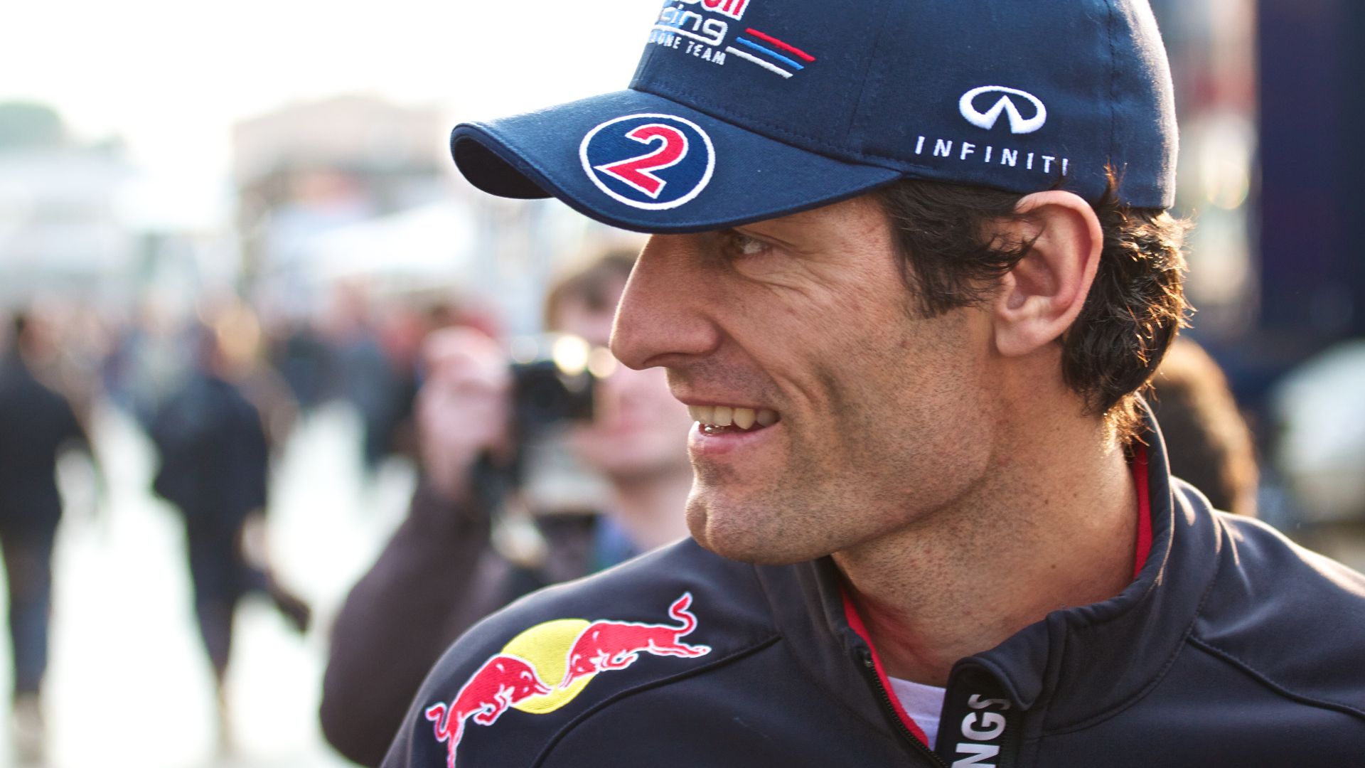 Mark Webber poses for a photo with a fan in the paddock