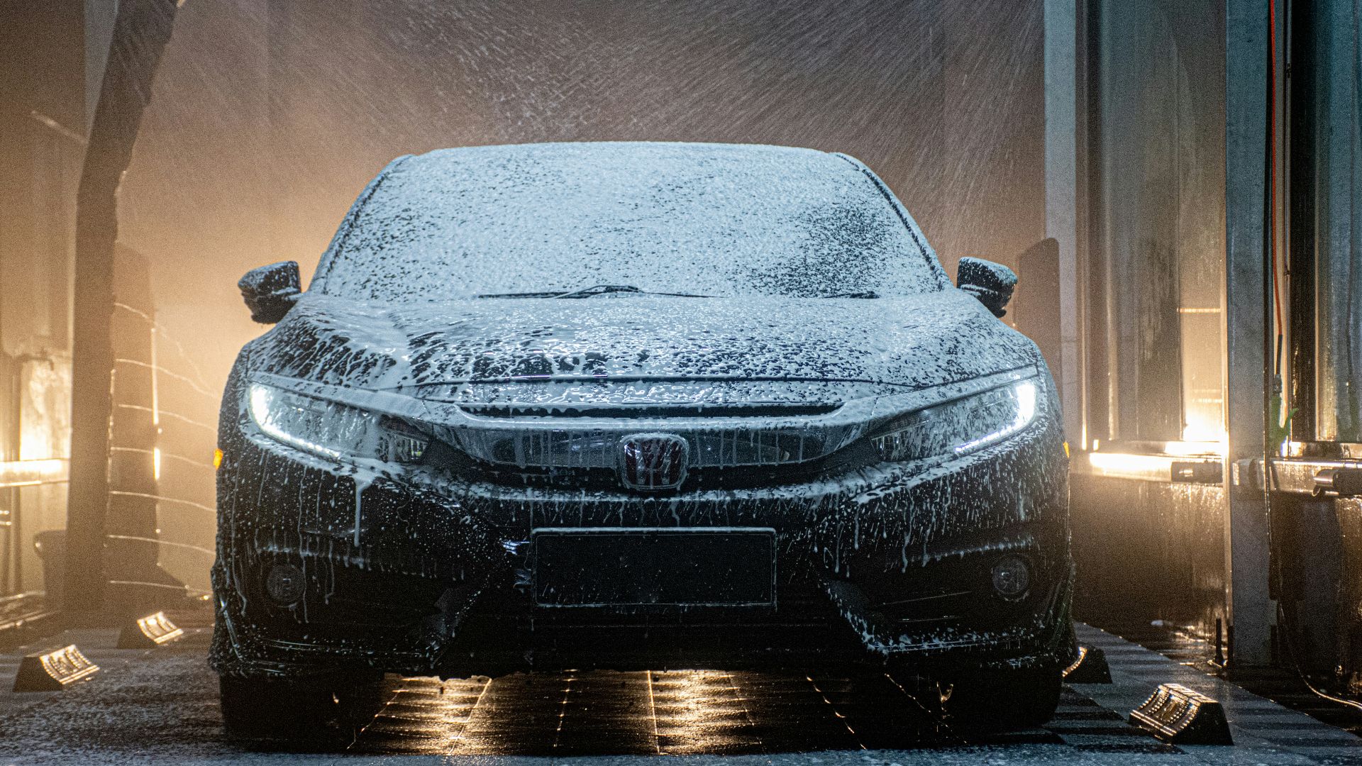 a car is covered in snow in a garage