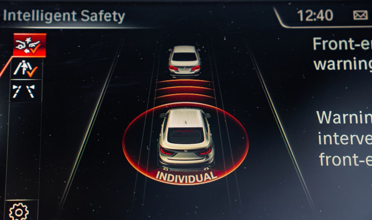Riga, Latvia. May 5, 2025. Dashboard screen of the BMW X6 showing the Intelligent Safety system interface with a collision warning and detailed safety information.
