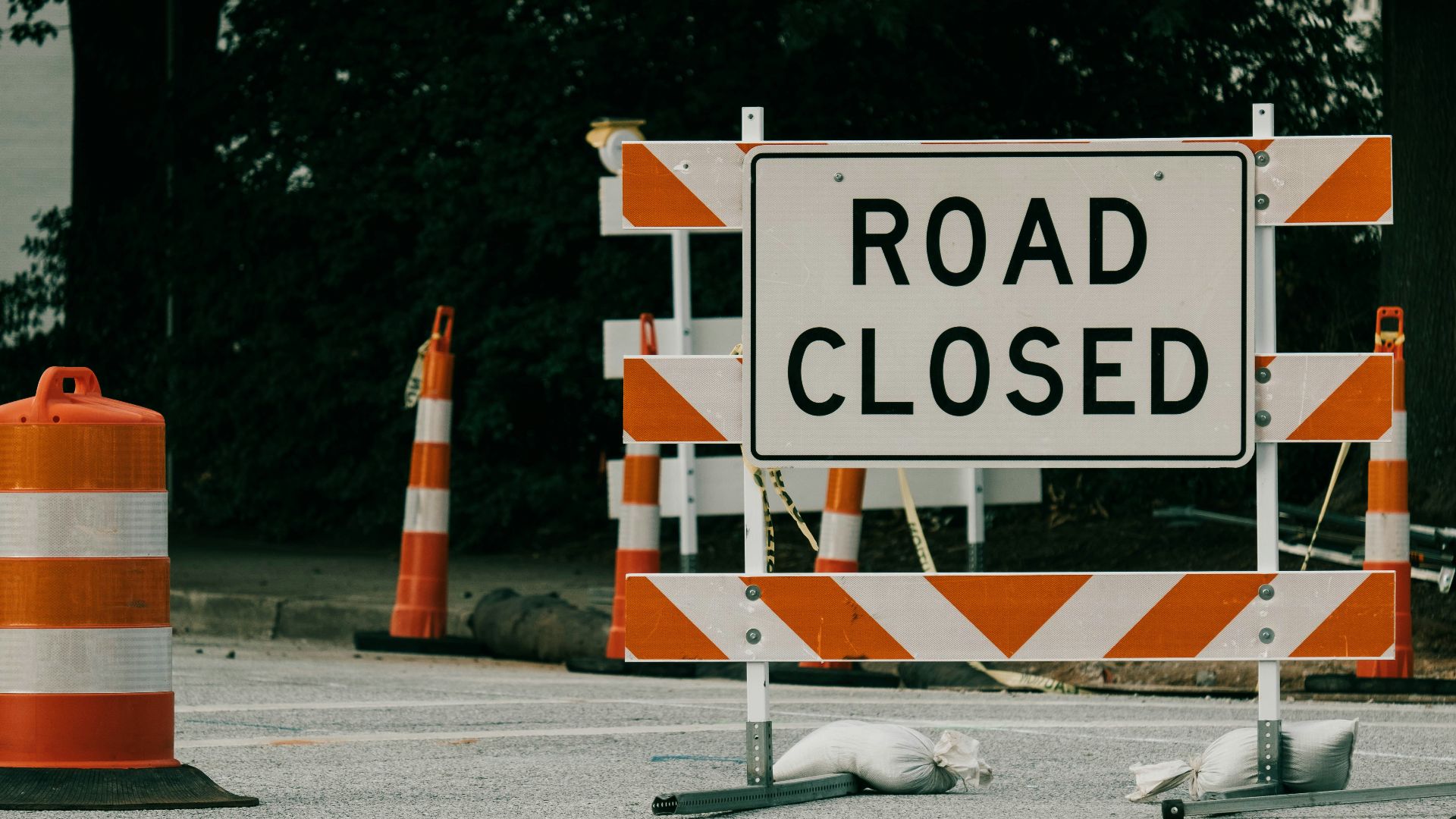 a road sign with orange cones