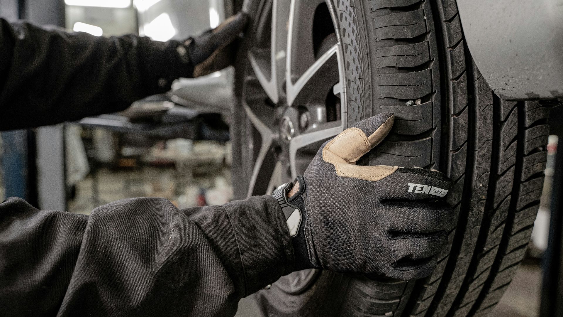 a man working on a tire in a garage