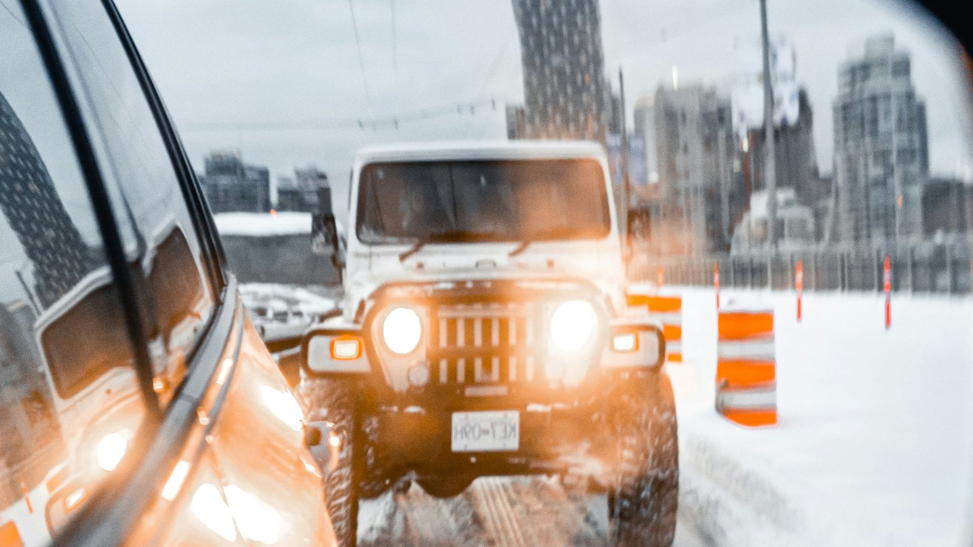 yellow car on road covered with snow during daytime