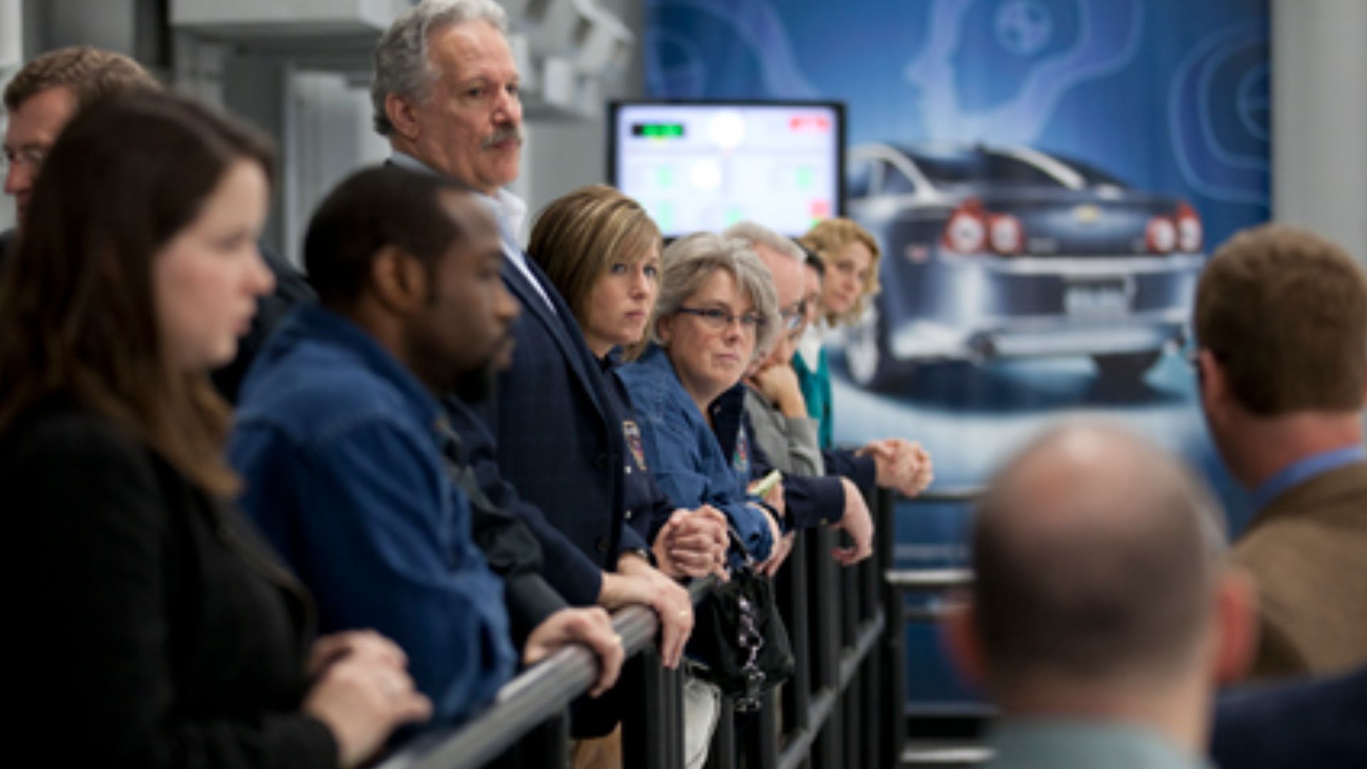 NTSB staff members are briefed on vehicle crash testing procedures at the IIHS Vehicle Research Center.