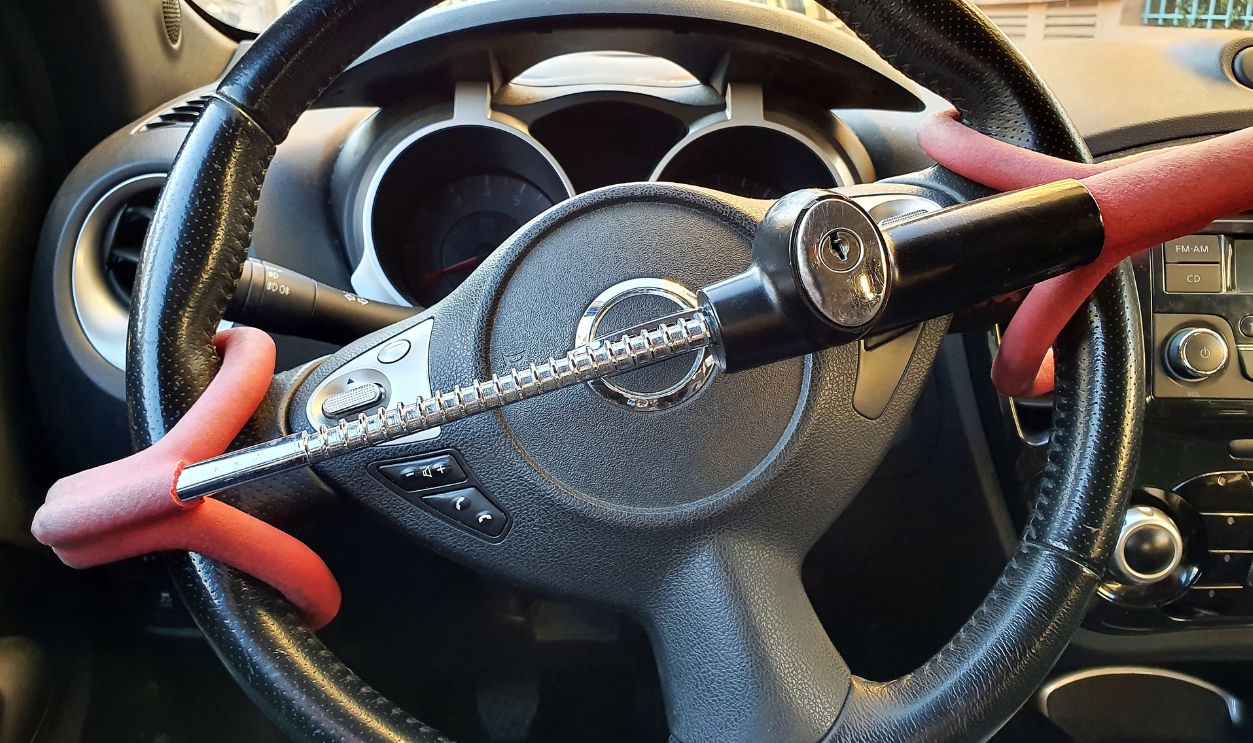 Anti-Theft Car Steering Wheel Lock Car Security. Black And Red Colors. Close Up View